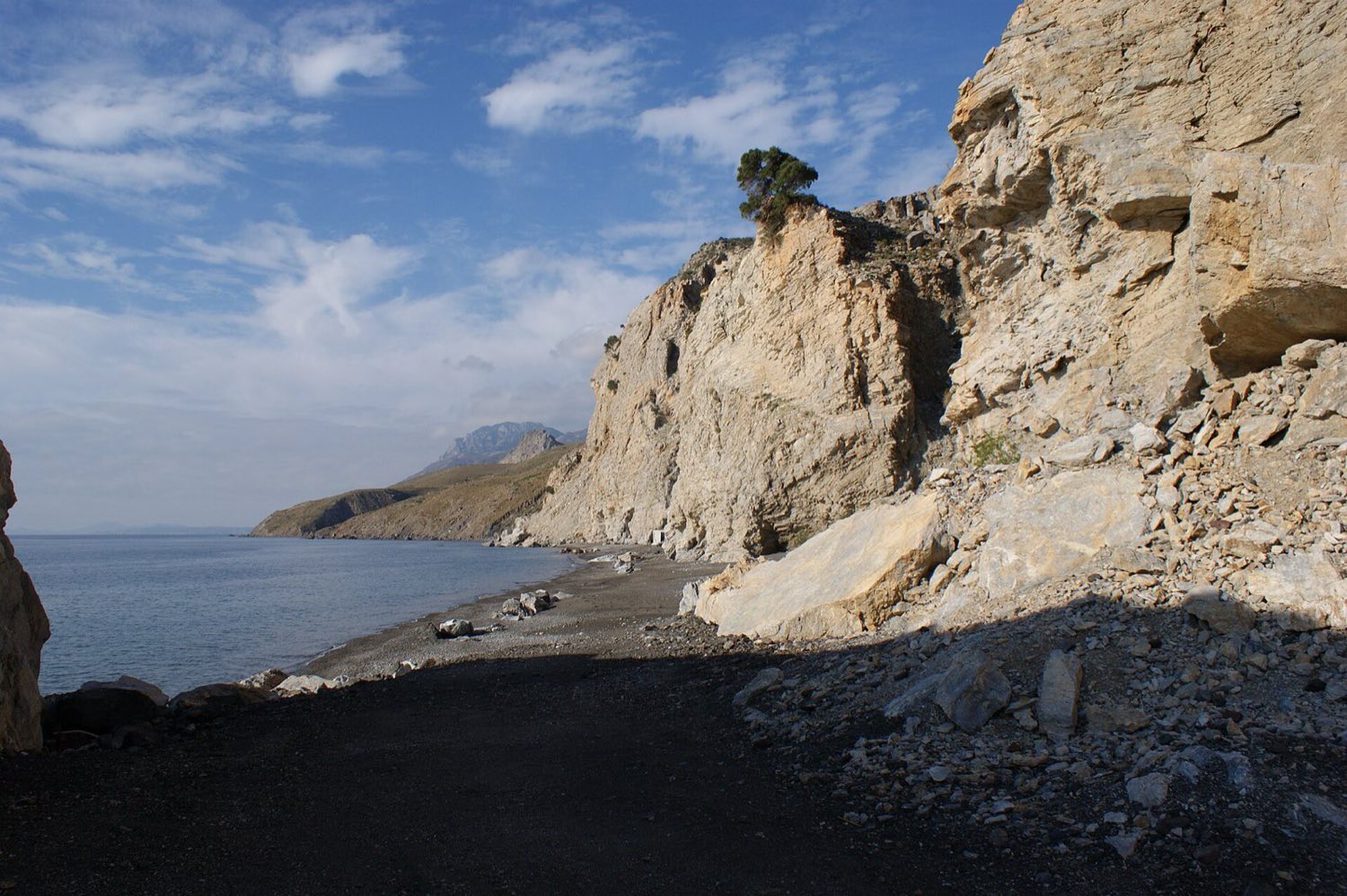 Stone-walled thermal pool where the Embros Therma hot spring meets the sea on Kos