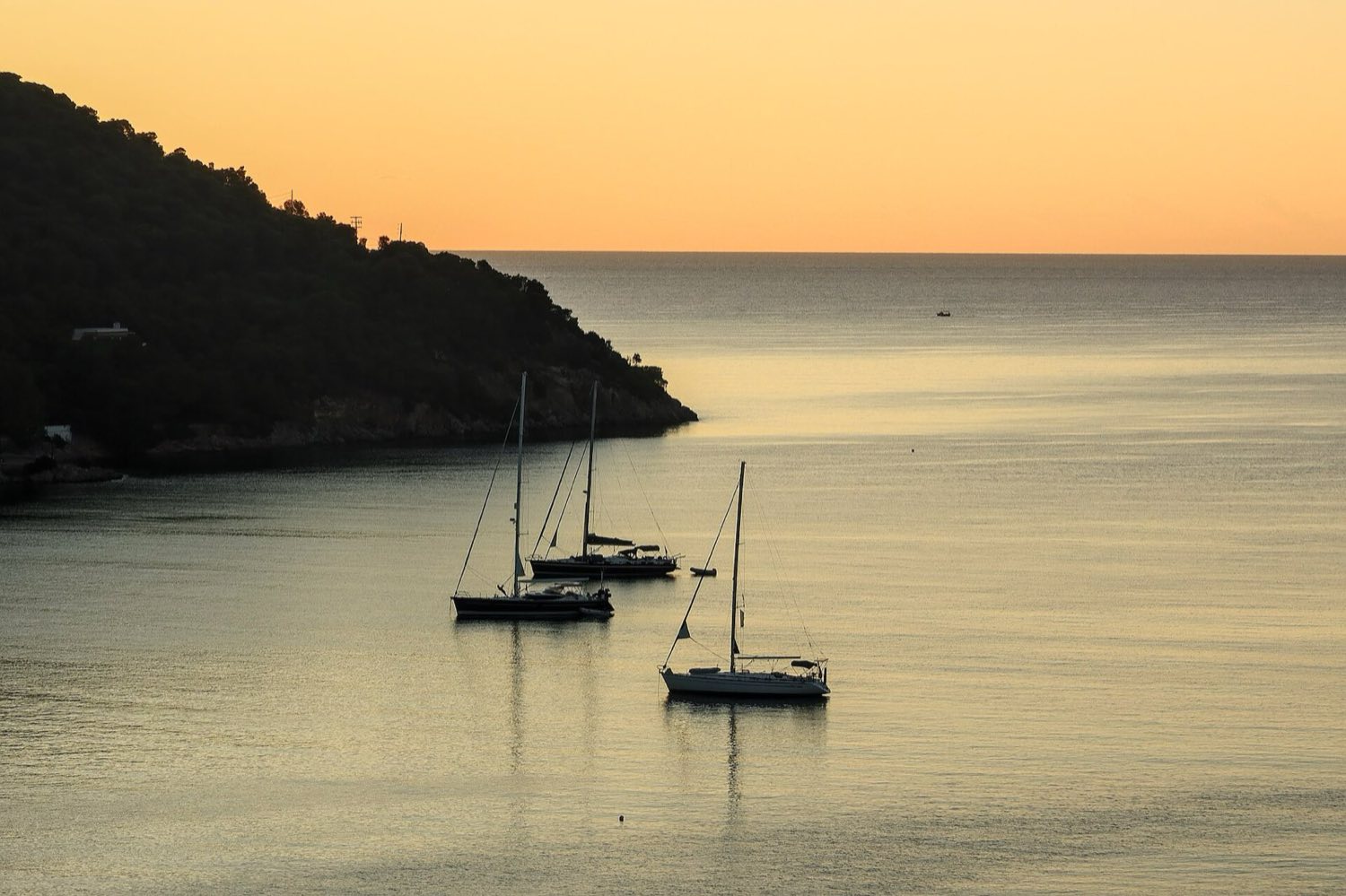 Private charter boat anchored alone in a quiet Aegean bay near Kos
