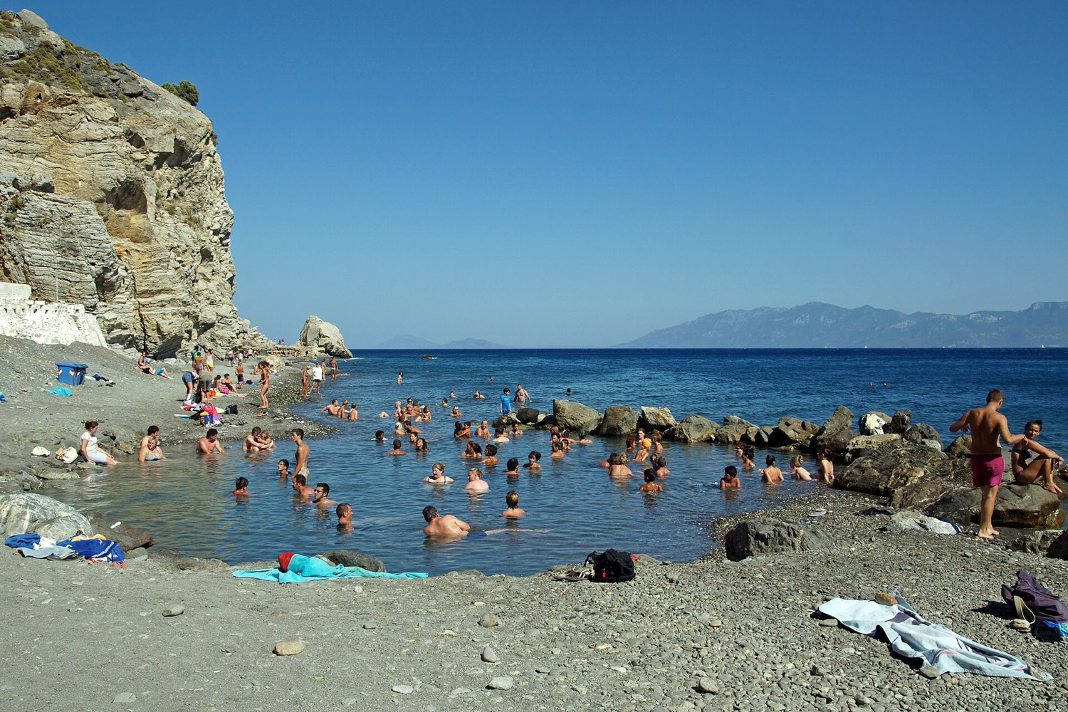 Pebble shoreline and clear deep water on the east coast of Kos near Agios Fokas