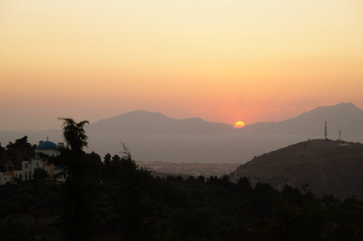 Sun dropping into the Aegean beyond Kalymnos, seen from the mountain village of Zia on Kos